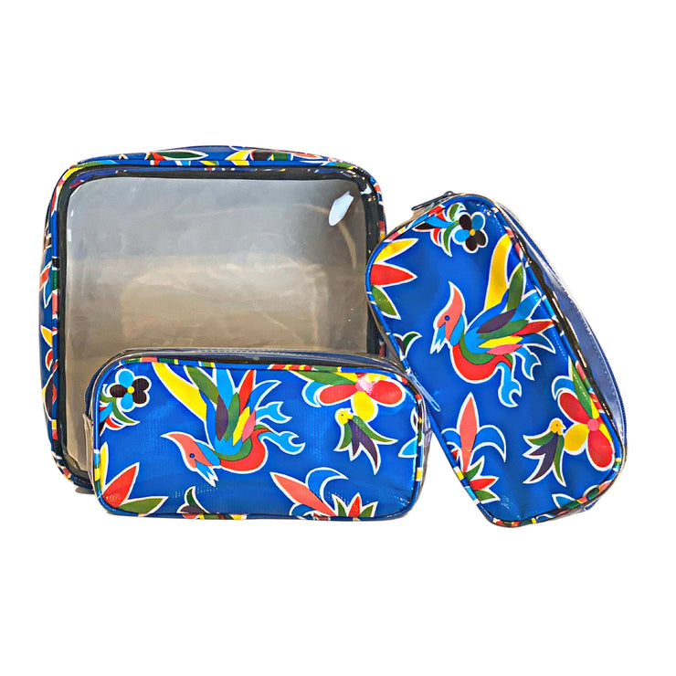 Front view: One large and two small travel cases, multi-colored flower/animal print on blue background.