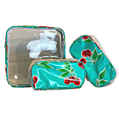 Front view: One large and two small travel cases, cherry print on green background.
