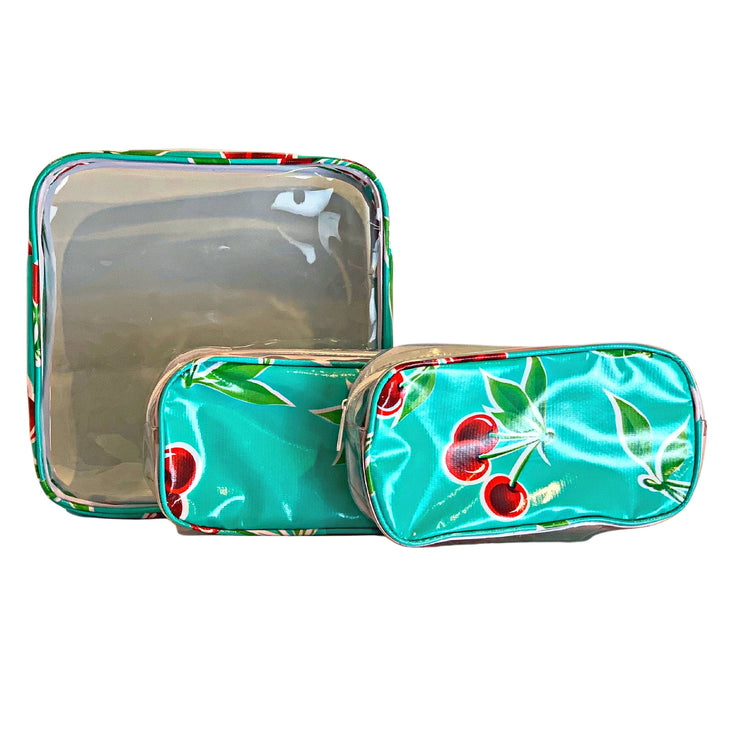 Front view: One large and two small travel cases, cherry print on green background.