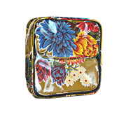 Side view: Two small travel cases, multi-colored flower print on mustard background, fitting inside large case.