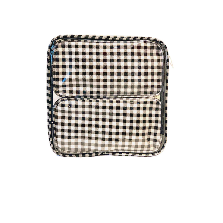 Front view: Two small travel cases, white and black checkered pattern, fitting inside the large case.
