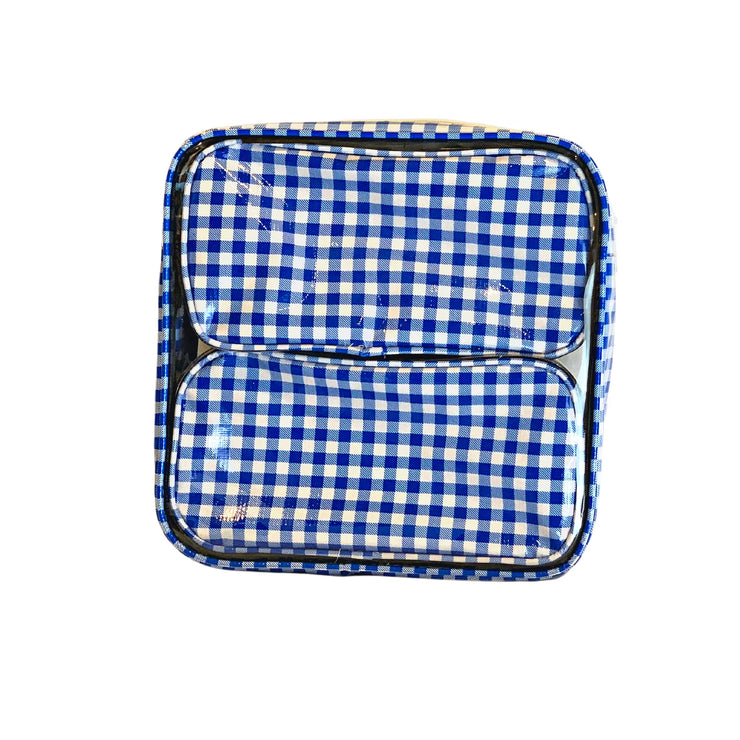Front view: Two small travel cases, white and blue checkered pattern, fitting in the large case.