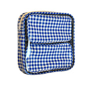 Side view: Two small travel cases, white and blue checkered pattern, fitting in the large case.