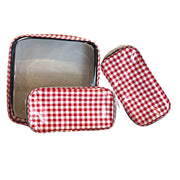 Front view: One large case and two small travel cases, white and red checkered pattern.