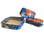 Above view: One large and two small travel cases, multi-colored floral print on blue background.