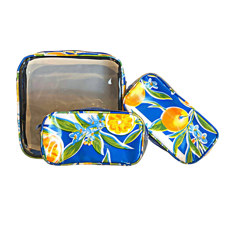 Front view: One large case and two small travel cases, multi-colored orange fruit and blossom print on blue background.