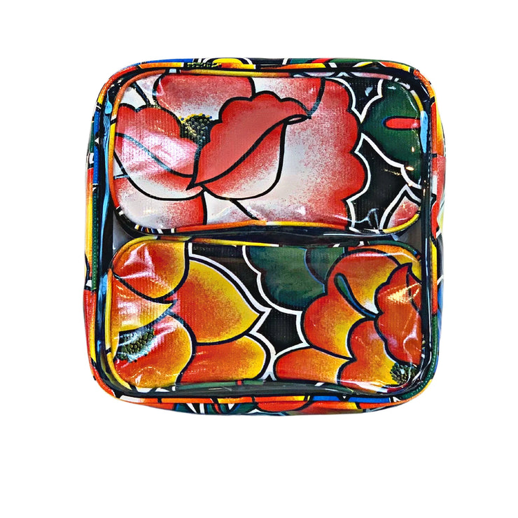 Front view: Two small travel cases, multi-colored floral print on black background, fitting in large case.