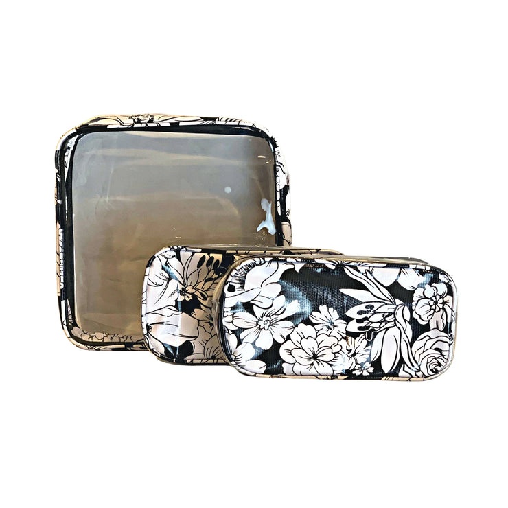 Front view: One large case and two small travel cases, white floral print on black background.