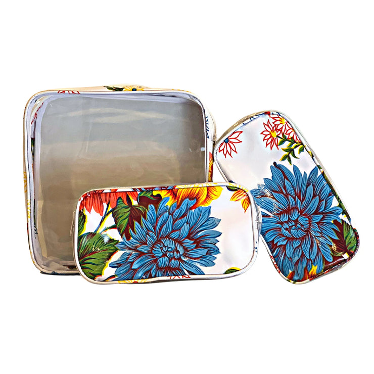 Front view: One large case and two small travel cases, multi-colored flower print on white background.