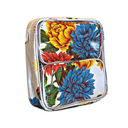 Side view: Two small travel cases, multi-colored flower print on white background, fitting in large case.