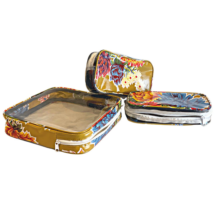 Above view:  One large case and two small travel cases, multi-colored flower print on mustard background.