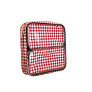 Side view: Two small travel cases, white and red checkered pattern, fitting inside the large case.