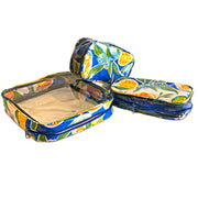 Above view: One large case and two small travel cases, multi-colored orange fruit and blossom print on blue background.