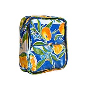 Front view: Two small travel cases, multi-colored orange fruit and blossom print on blue background, fitting inside large case.