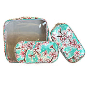 Front view:  One large case and two small travel cases, multi-colored cherry blossom print on green background.