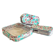 Above view: One large case and two small travel cases, multi-colored cherry blossom print on green background.
