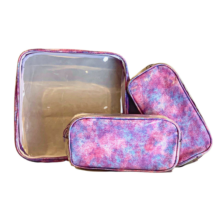 Front view: One large and two small travel cases, blue, pink and purple splatter print.