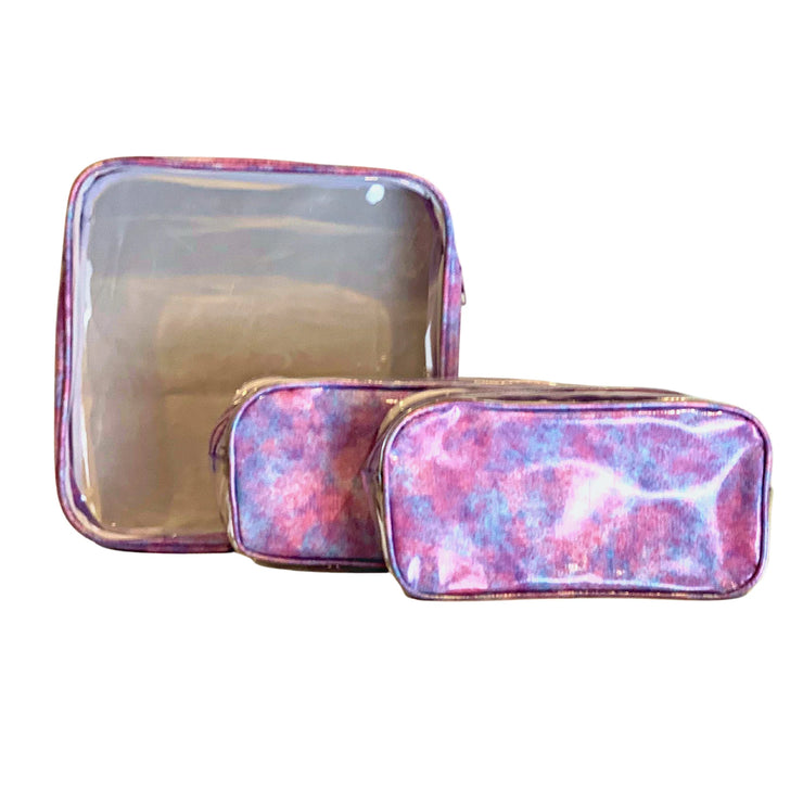 Front view: One large and two small travel cases, blue, pink and purple splatter print.