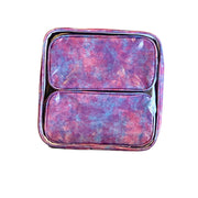 Front view: Two small travel cases, blue, pink and purple splatter print, fitting inside large case.