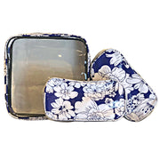Front view:  One large case and two small travel cases, white floral print on blue background.