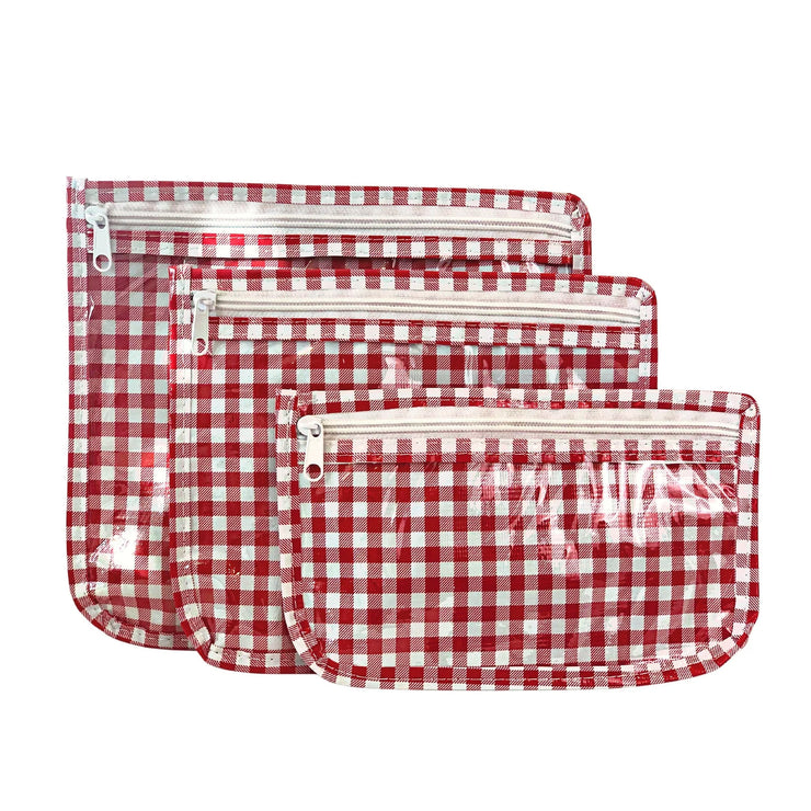 Front view: Small, medium and large slim travel bags, white zippers and white and red checkered pattern.