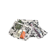 Above view: Small, medium and large slim travel bags, white zippers and white floral print on a black background, showing travel items through transparent background. 