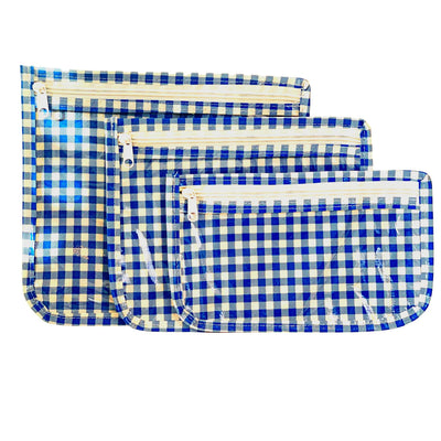 Front view: Small, medium and large slim travel bags, white zippers and white and blue checkered pattern.