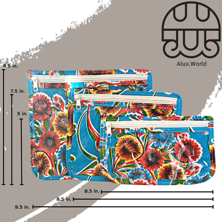 Front view: Small, medium and large slim travel bags, white zippers and multi-colored floral print on blue background, with dimensions.