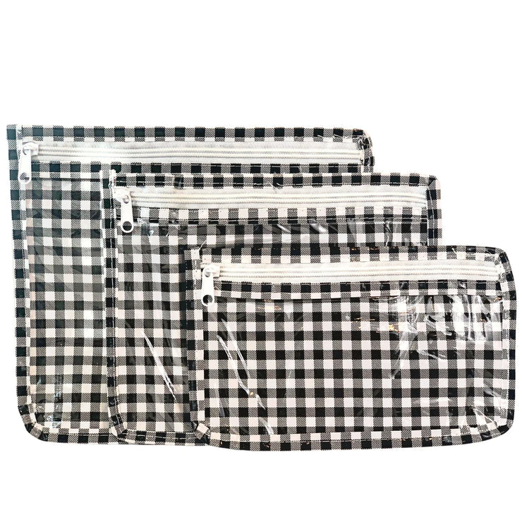 Front view: Small, medium and large slim travel bags, white zippers and white and black checkered pattern.