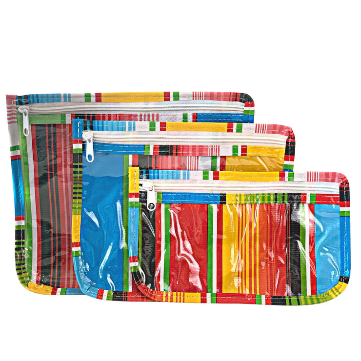 Front view: Small, medium and large slim travel bags, white zippers and multi-colored striped pattern.