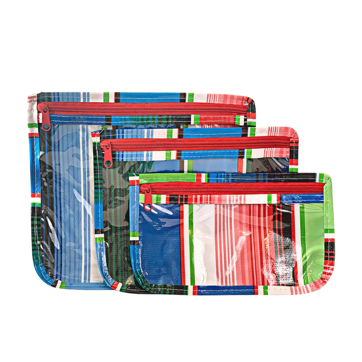 Front view: Small, medium and large slim travel bags, red zippers and multi-colored striped pattern.