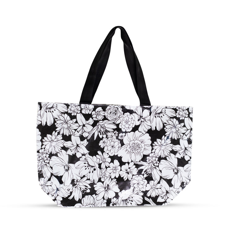 Front view: White floral print on black background tote. 