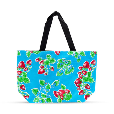 Front view: Strawberry print on blue background tote with black handles. 