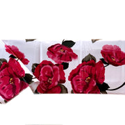 Side view: Roses print on white background tablecloth covering table.