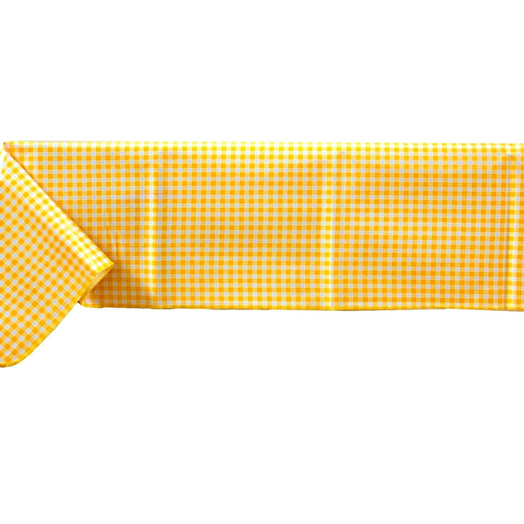 Side view: Yellow and white checkered pattern tablecloth covering table.