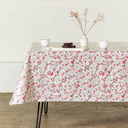 Side view: Above view: Cherry blossom print on gray background tablecloth covering table, with grape platter and dried grass centerpiece.