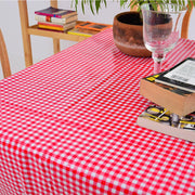 Above view: Red and white checkered pattern tablecloth covering table, potted plant centerpiece.