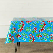 Side view: Strawberry print on blue background tablecloth covering table, without centerpiece.