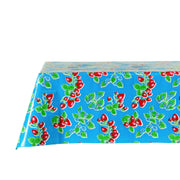 Side view: Strawberry print on blue background tablecloth covering table, without centerpiece.