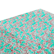 Above view: Cherry blossom print on mint green background tablecloth covering table.