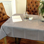 Side view: Black and white checkered pattern tablecloth, potted plant centerpiece. 