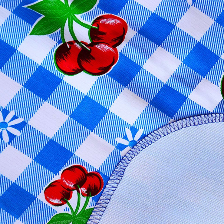 Close up: Fruit print on blue and white checkered background with white underside folded up to show contrast.