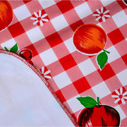 Close up: Fruit print on red and white checkered background, with white underside folded up to show contrast.