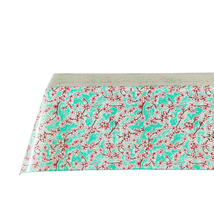 Side view: Cherry blossom print on mint green background tablecloth covering table.