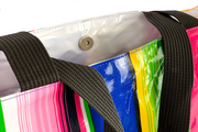 Close up: Multi-colored vertical striped pattern tote with black handles, glossy version.