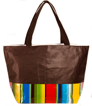 Front: Brown tote with multi-color striped pattern base with brown grab handles. 