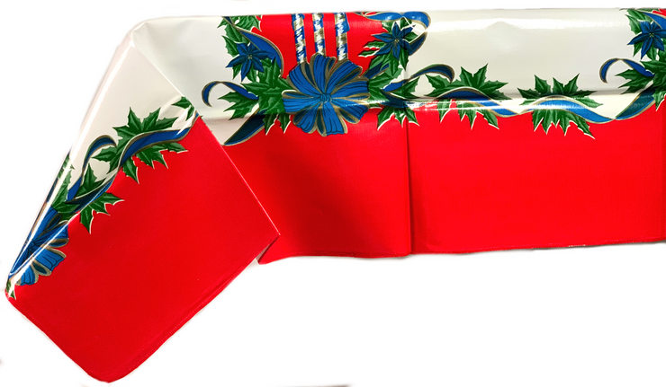 Side view: Blue ribbons with poinsettia edging on white and red striped background tablecloth.