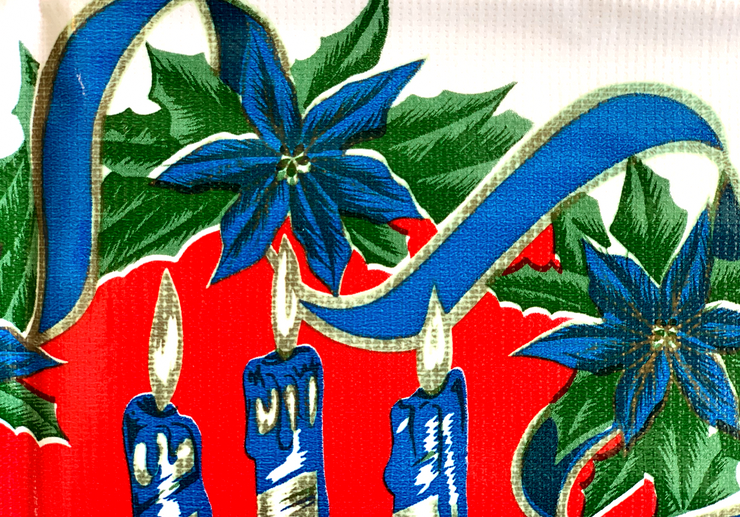 Close up: Blue ribbons with poinsettia edging on white and red striped background tablecloth.