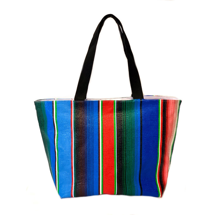 Front view: Multi-colored vertical striped pattern tote with black handles.