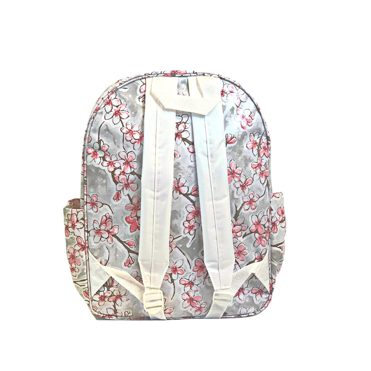 Back view: Sakura Backpack, cherry blossom print on gray background, cherry blossom print back panel, white shoulder straps, white grab handle.